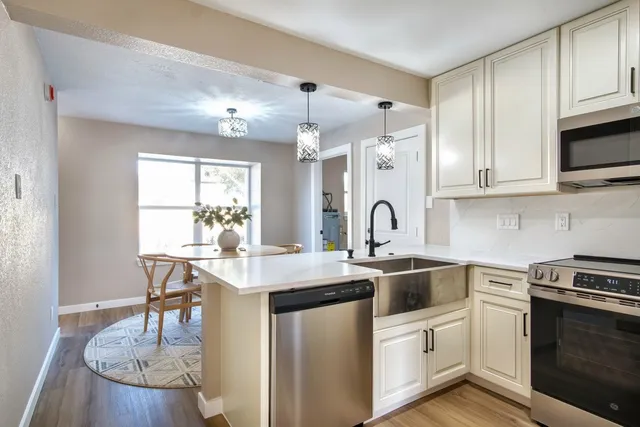 a kitchen with stainless steel appliances a refrigerator and a stove top oven