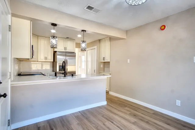 a open kitchen with a sink and chandelier