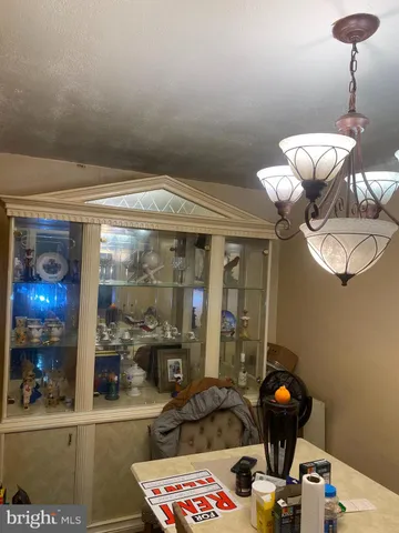 a view of a dining room with furniture and a chandelier fan