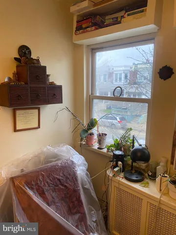 a bed sitting in a bedroom next to a window