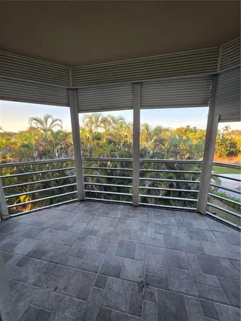 a view of a room with stairs and a floor to ceiling window