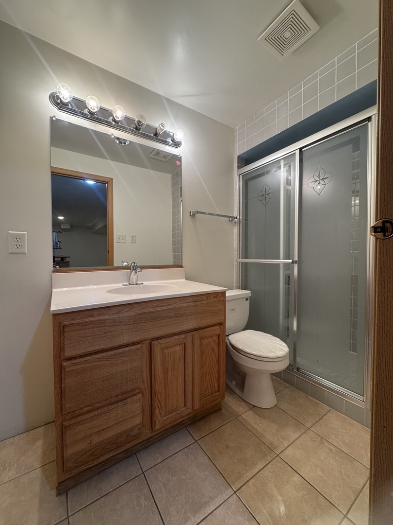1716 William Drive Romeoville, IL 60446 - Photo 10 of 18 a bathroom with a toilet sink and mirror
