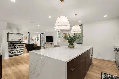 a view of kitchen with sink microwave and refrigerator