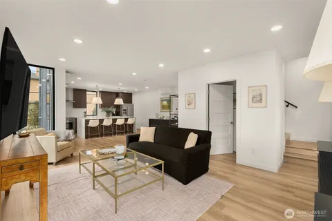 a living room with furniture wooden floor and a flat screen tv