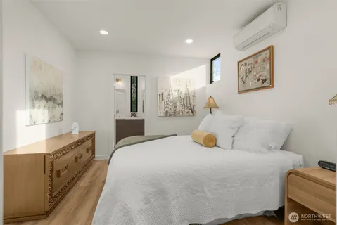 a bedroom with a bed and a large mirror