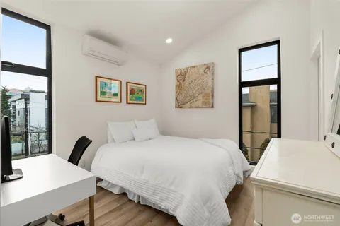 a bedroom with a bed and a desk