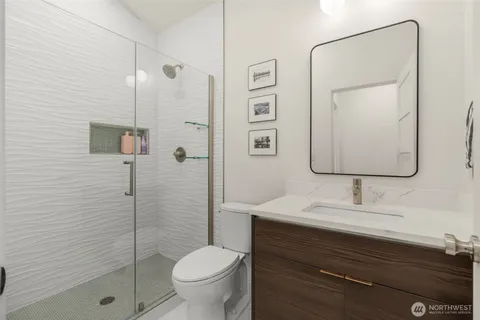 a bathroom with a sink toilet and shower