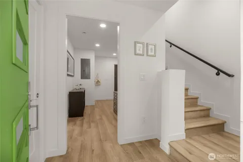 a view of a kitchen with furniture and wooden floor