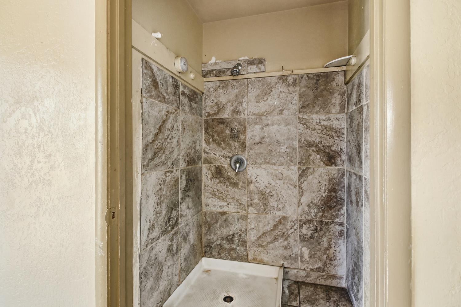 7334 Doc Adams Road Marysville, CA 95901 - Photo 19 of 30 a bathroom with a shower and a toilet