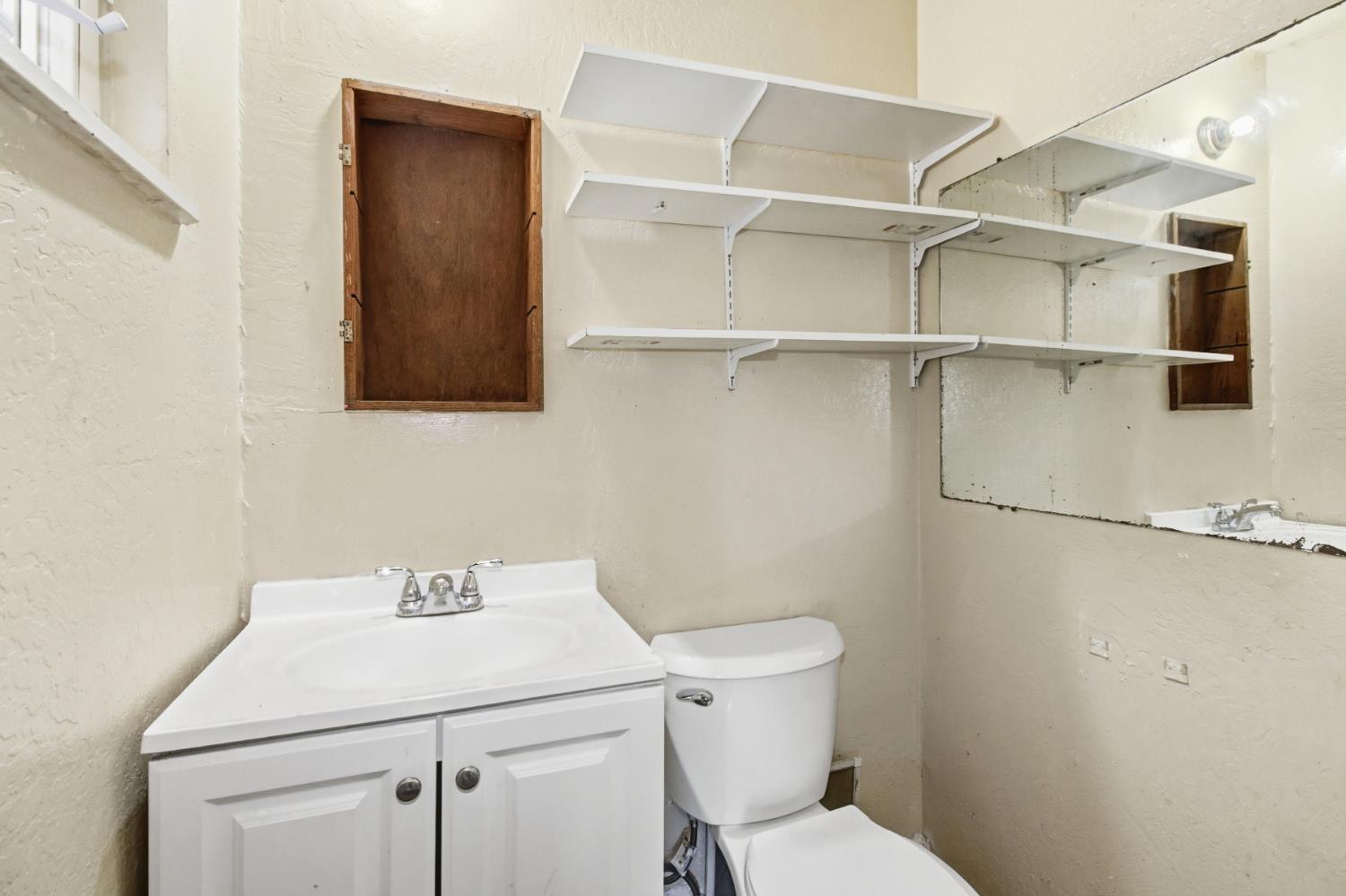 7334 Doc Adams Road Marysville, CA 95901 - Photo 20 of 30 a bathroom with a sink mirror vanity and toilet