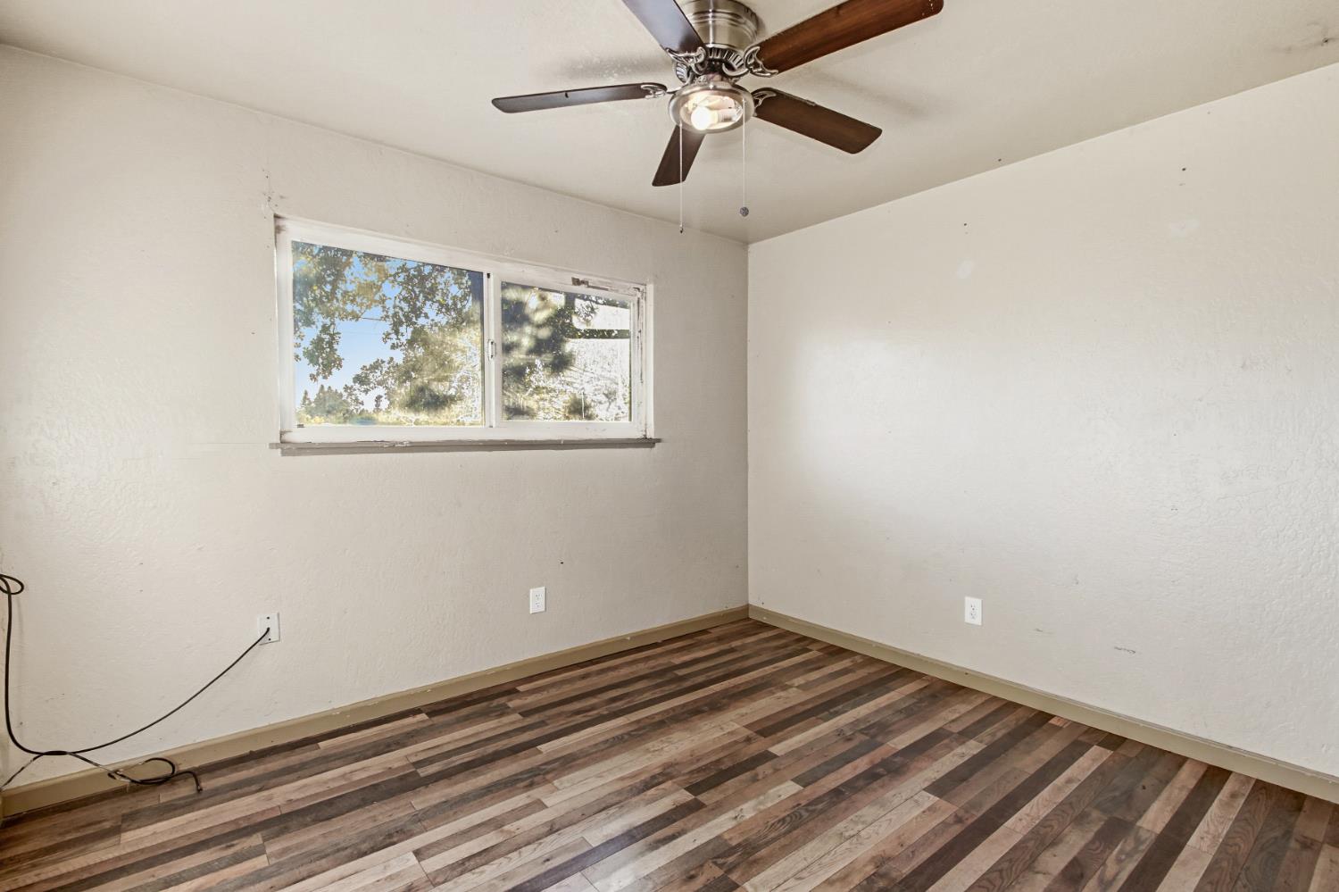 7334 Doc Adams Road Marysville, CA 95901 - Photo 25 of 30 a view of a room with wooden floor and windows
