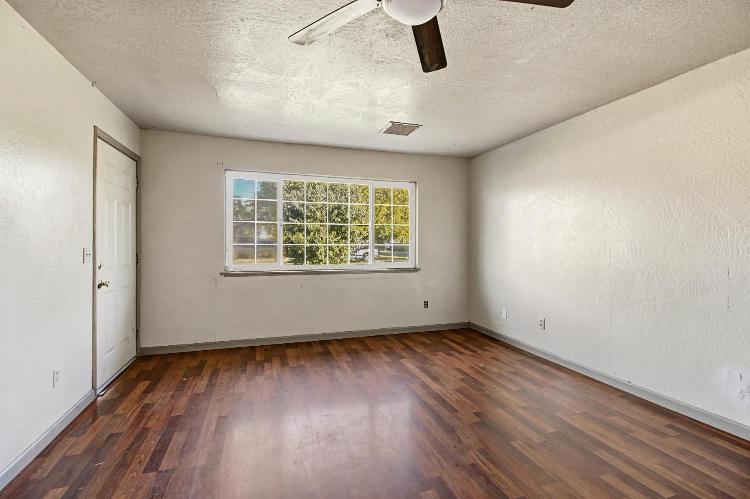 7334 Doc Adams Road Marysville, CA 95901 - Photo 5 of 30 wooden floor in an empty room with a window