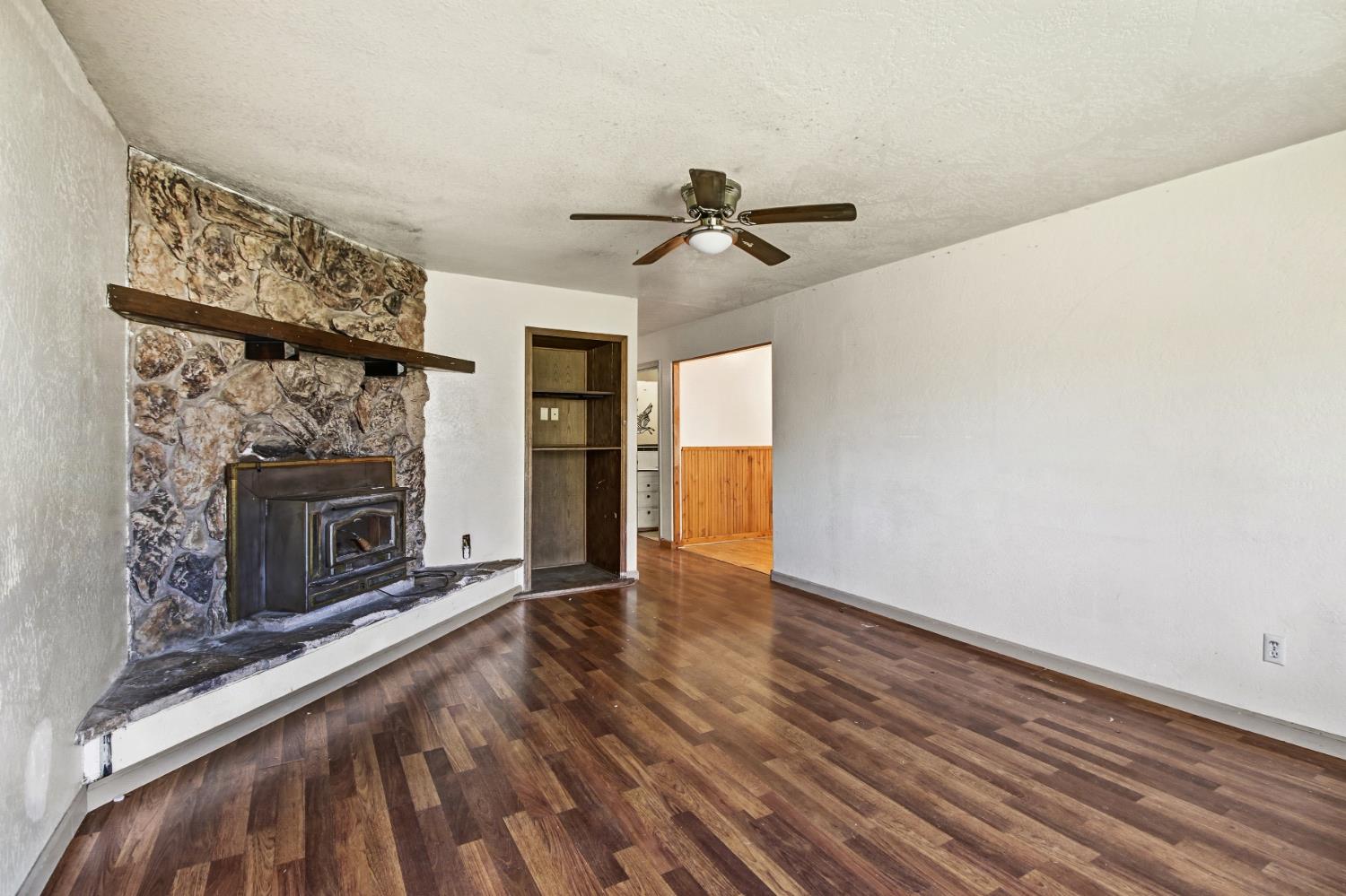7334 Doc Adams Road Marysville, CA 95901 - Photo 7 of 30 a view of empty room with wooden floor and fireplace