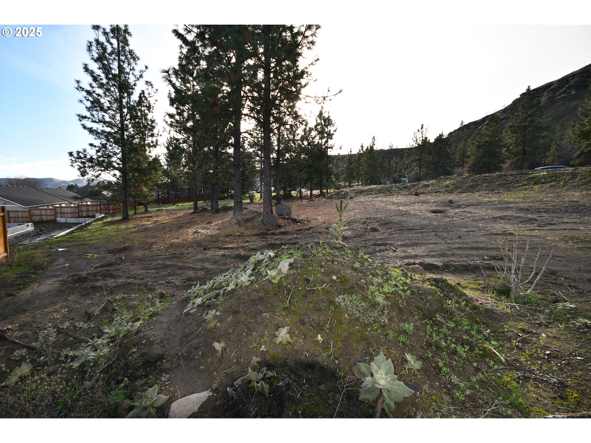 West 15th Street, Unit 36 The Dalles, OR 97058 - Photo 18 of 23 a view of a dry yard with wooden fence