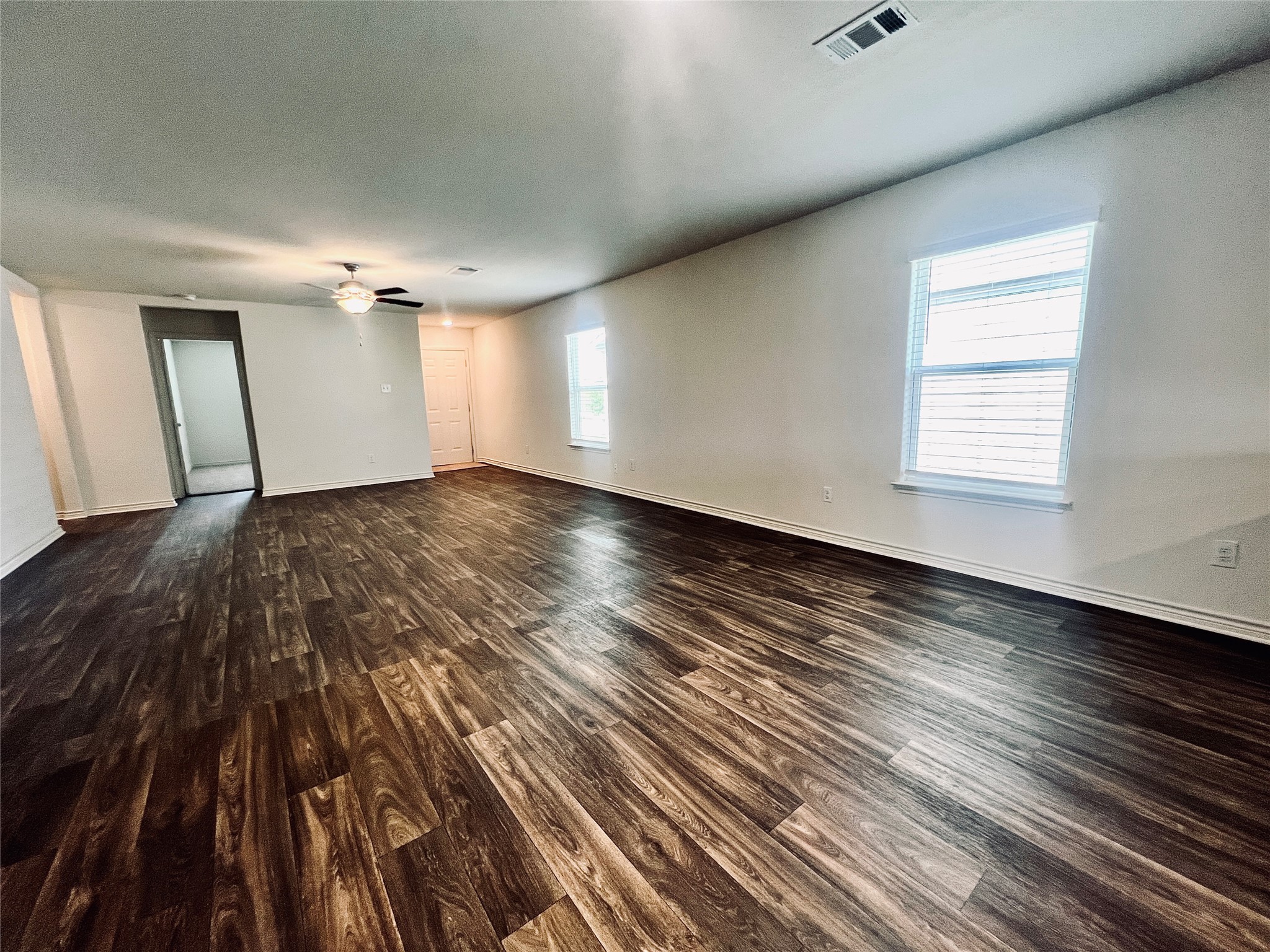 520 Locksley Cove Jarrell, TX 76537 - Photo 8 of 27 Rich hardwood-style flooring extends across this spacious living area, awaiting your personal touch.