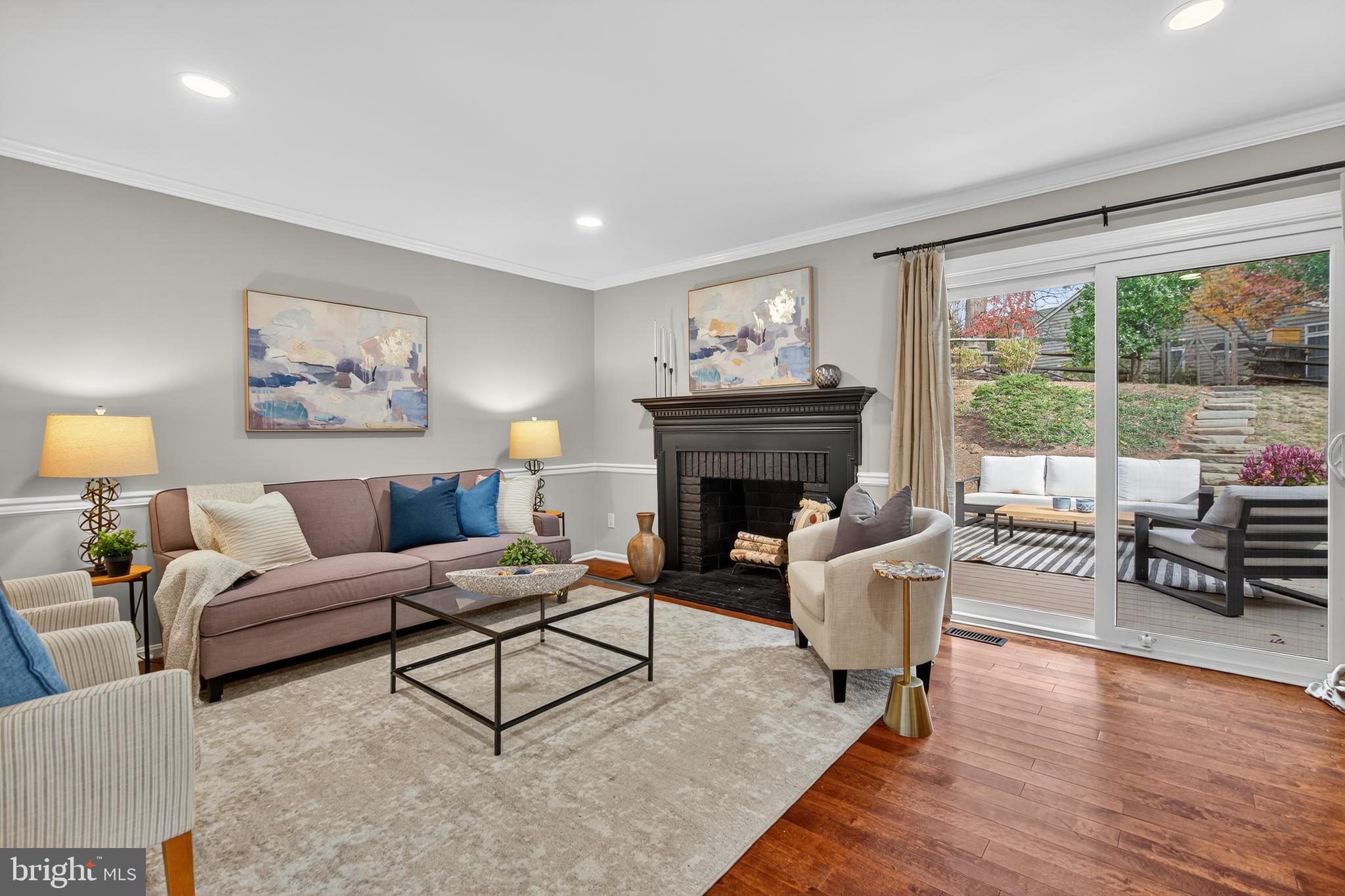 12100 Triple Crown Road North Potomac, MD 20878 - Photo 22 of 66 a living room with furniture a large window and a fireplace