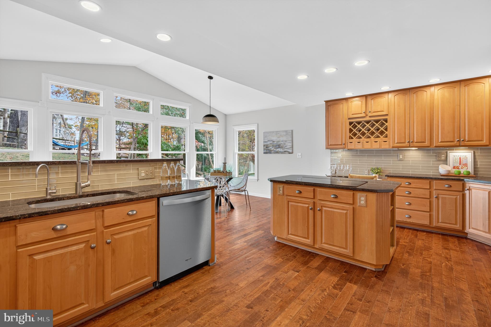 12100 Triple Crown Road North Potomac, MD 20878 - Photo 26 of 66 a kitchen with stainless steel appliances granite countertop wooden cabinets a sink and dishwasher with wooden floor