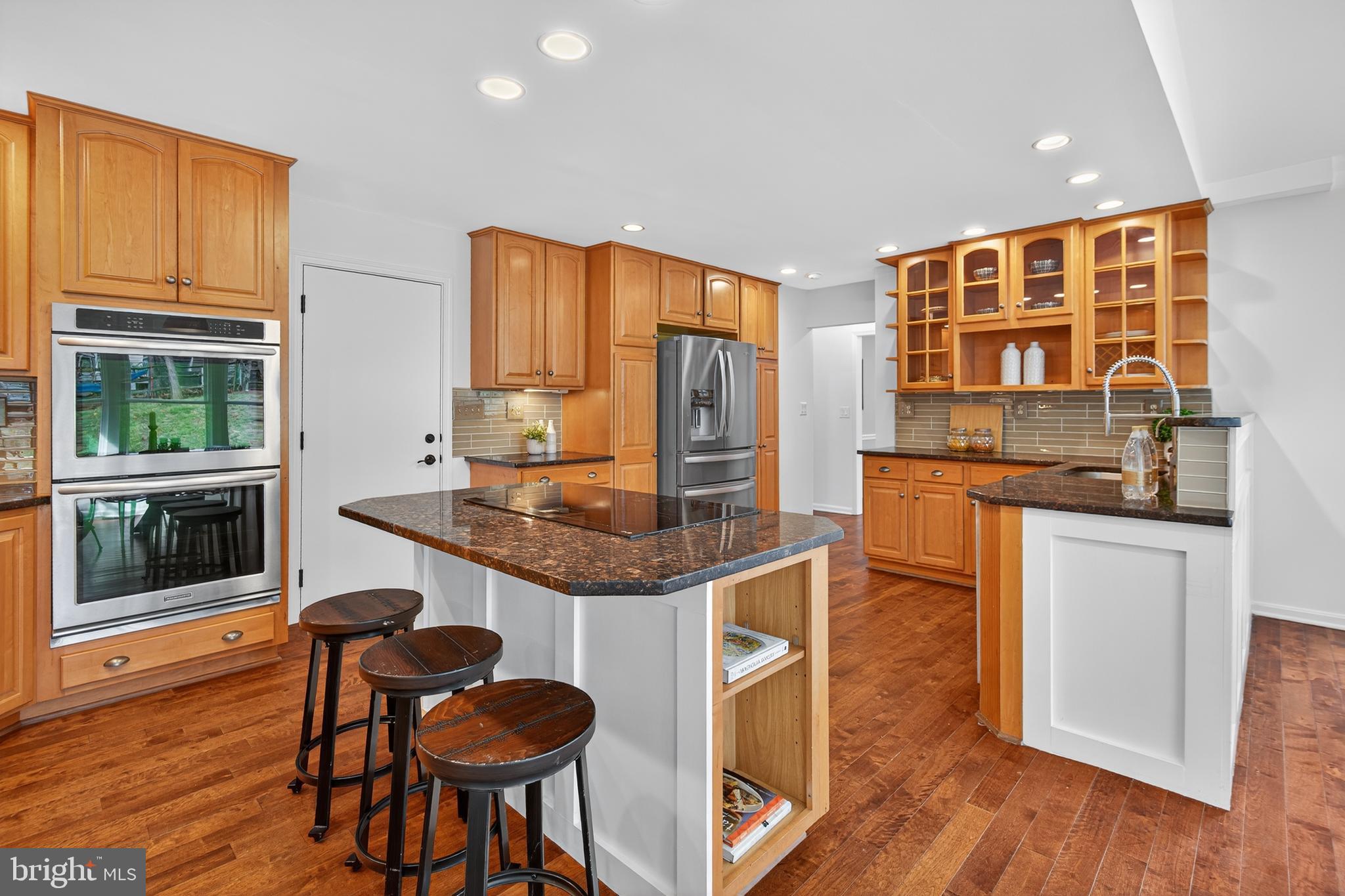 12100 Triple Crown Road North Potomac, MD 20878 - Photo 29 of 66 a kitchen with stainless steel appliances granite countertop a stove and a refrigerator