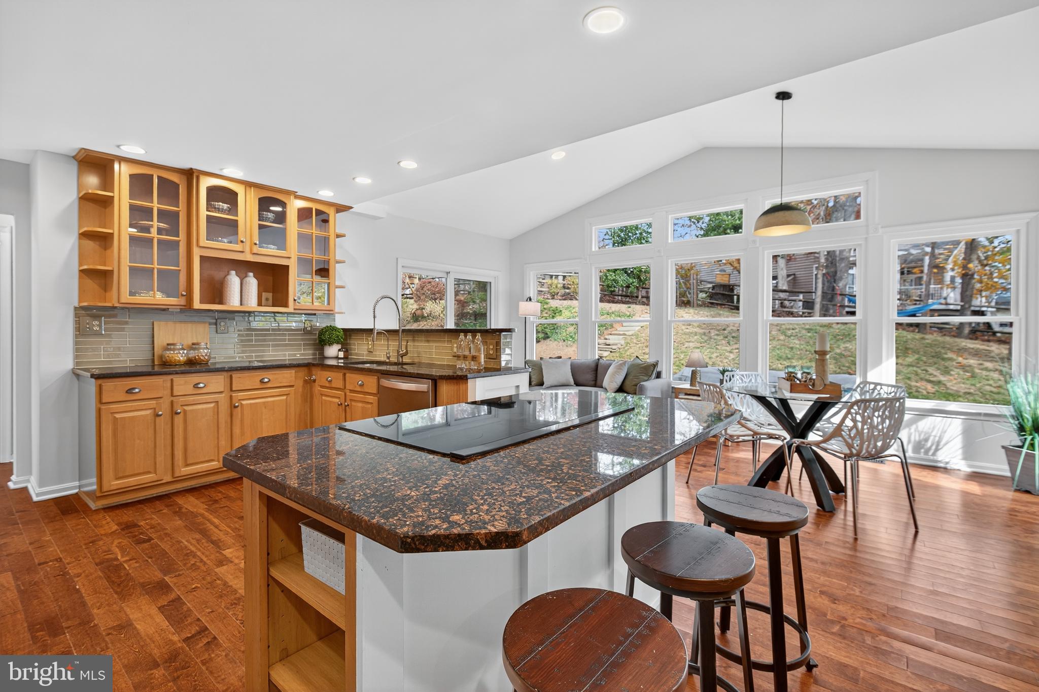 12100 Triple Crown Road North Potomac, MD 20878 - Photo 30 of 66 a kitchen with granite countertop kitchen island stainless steel appliances a stove a table and chairs in it