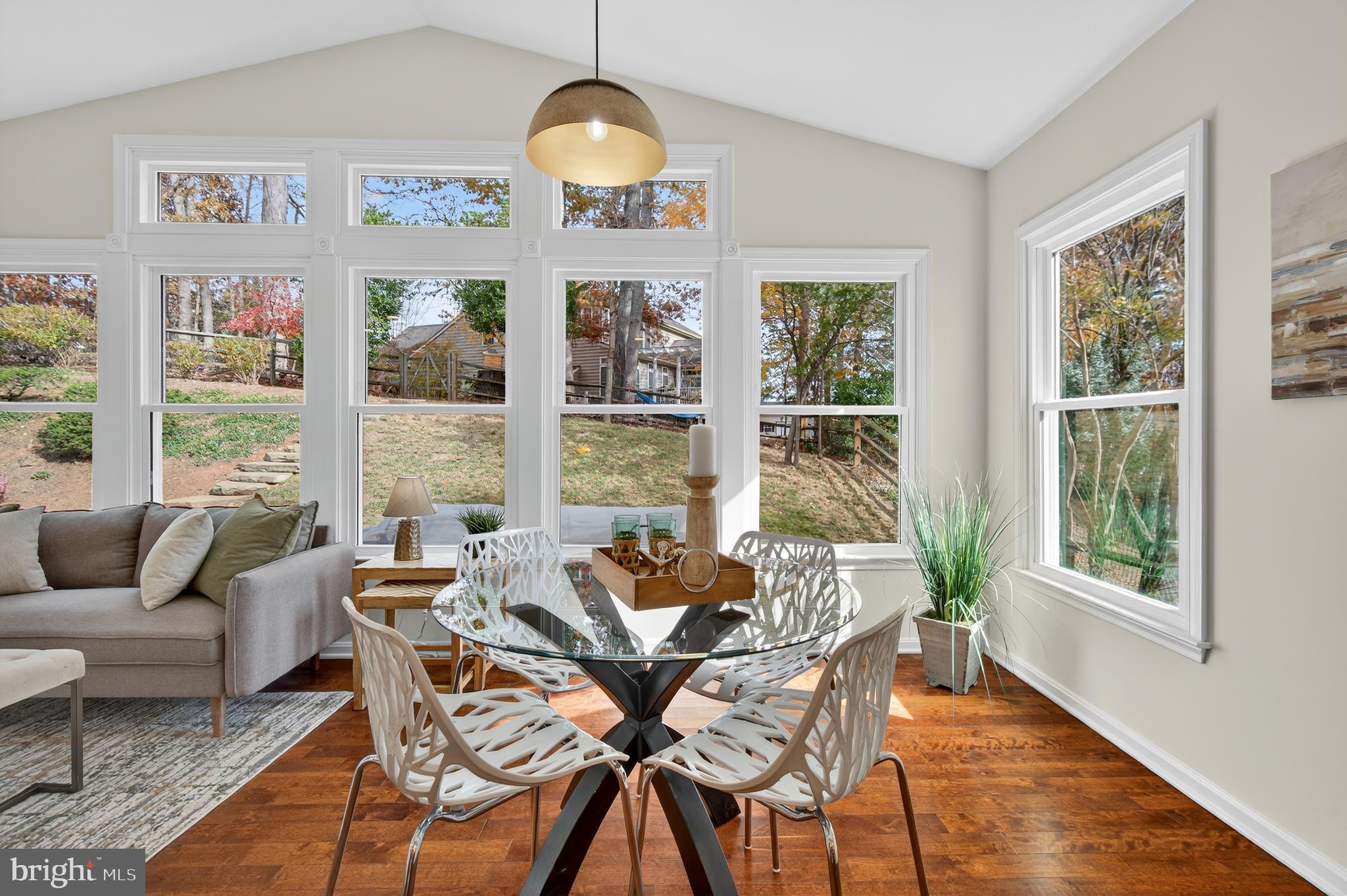 12100 Triple Crown Road North Potomac, MD 20878 - Photo 34 of 66 a dining room with furniture a chandelier and wooden floor