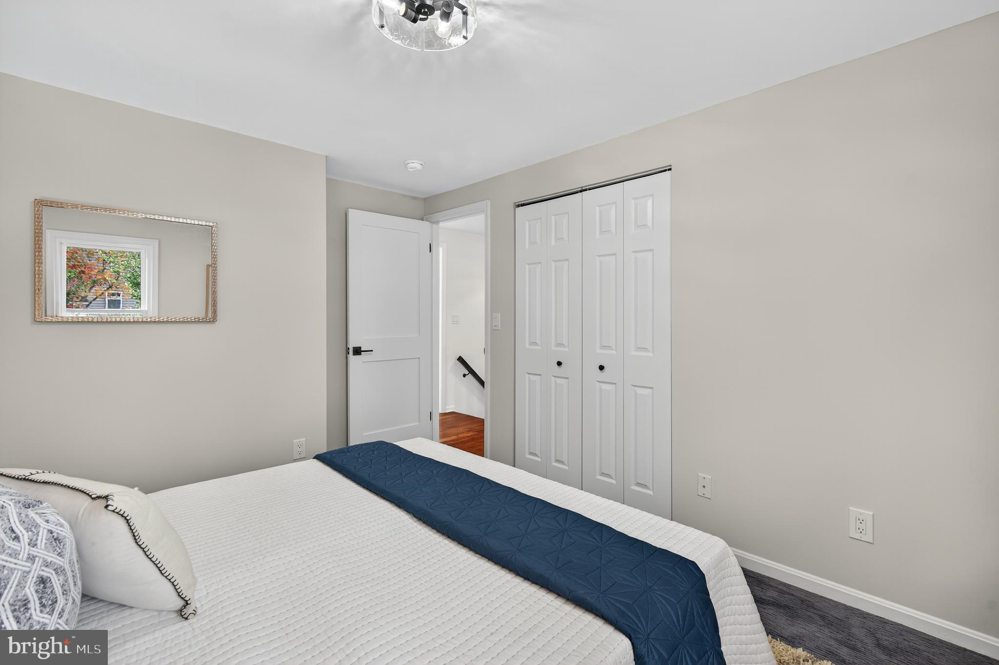 12100 Triple Crown Road North Potomac, MD 20878 - Photo 47 of 66 a bedroom with a bed and a chandelier