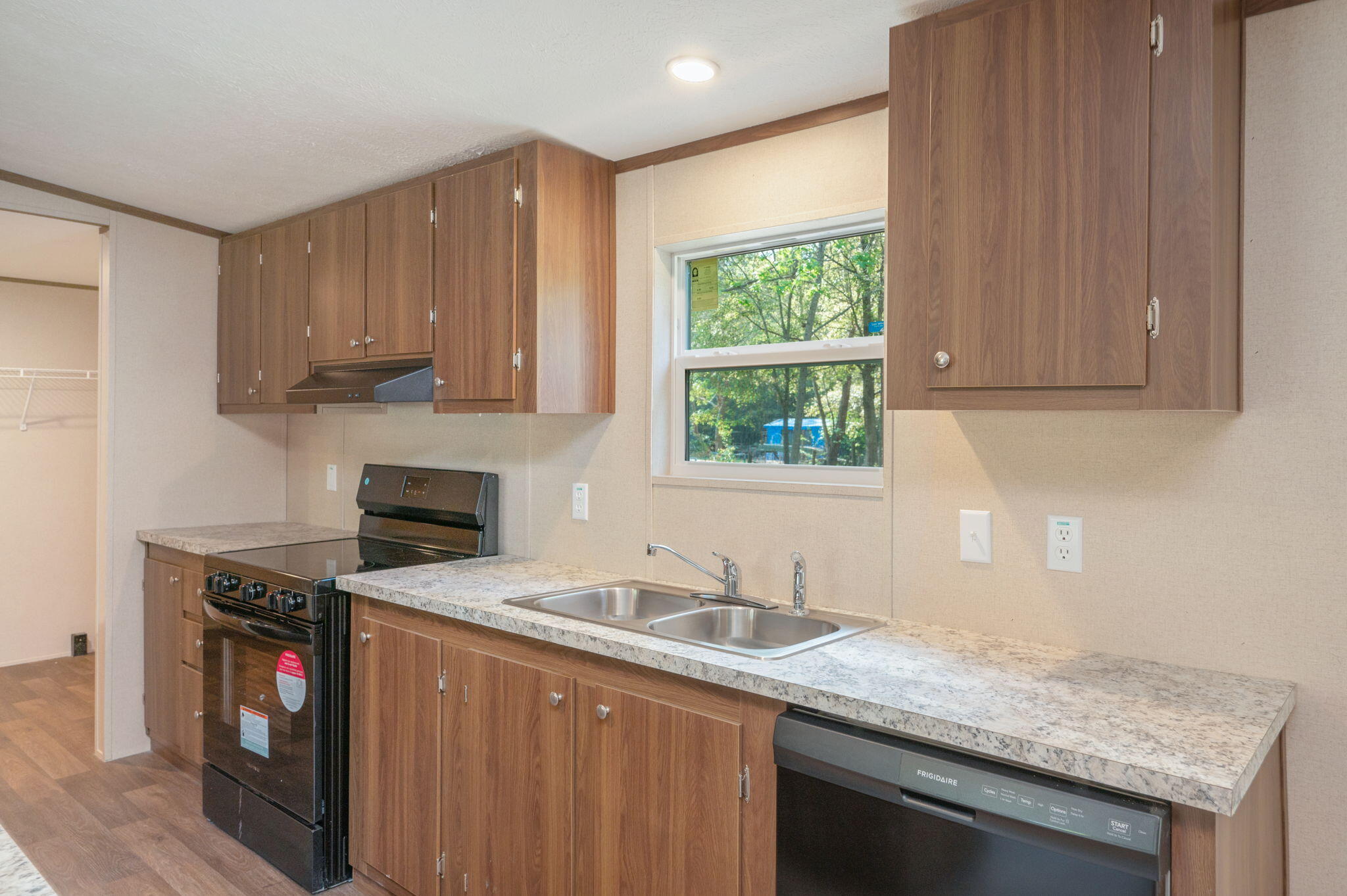 8255 Punjob Road Milton, FL 32583 - Photo 13 of 37 a kitchen with granite countertop a sink stove and cabinets