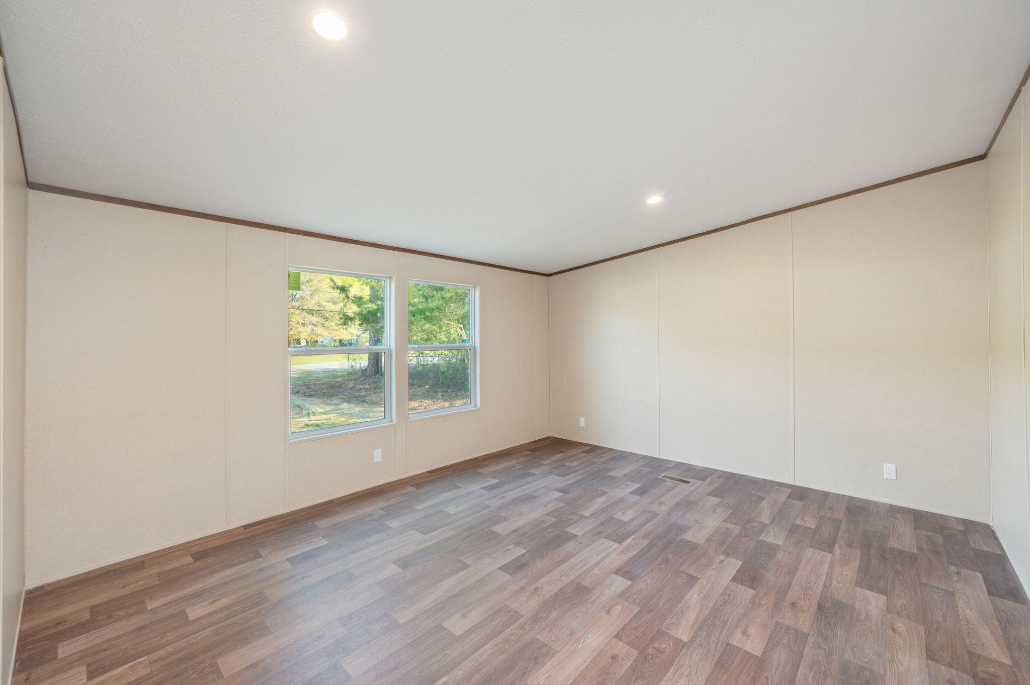 8255 Punjob Road Milton, FL 32583 - Photo 23 of 37 an empty room with wooden floor and windows