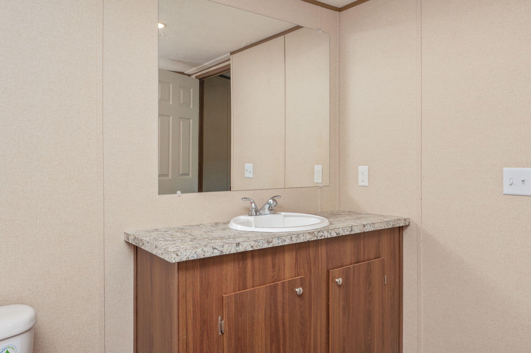 8255 Punjob Road Milton, FL 32583 - Photo 26 of 37 a bathroom with a granite countertop sink and a mirror