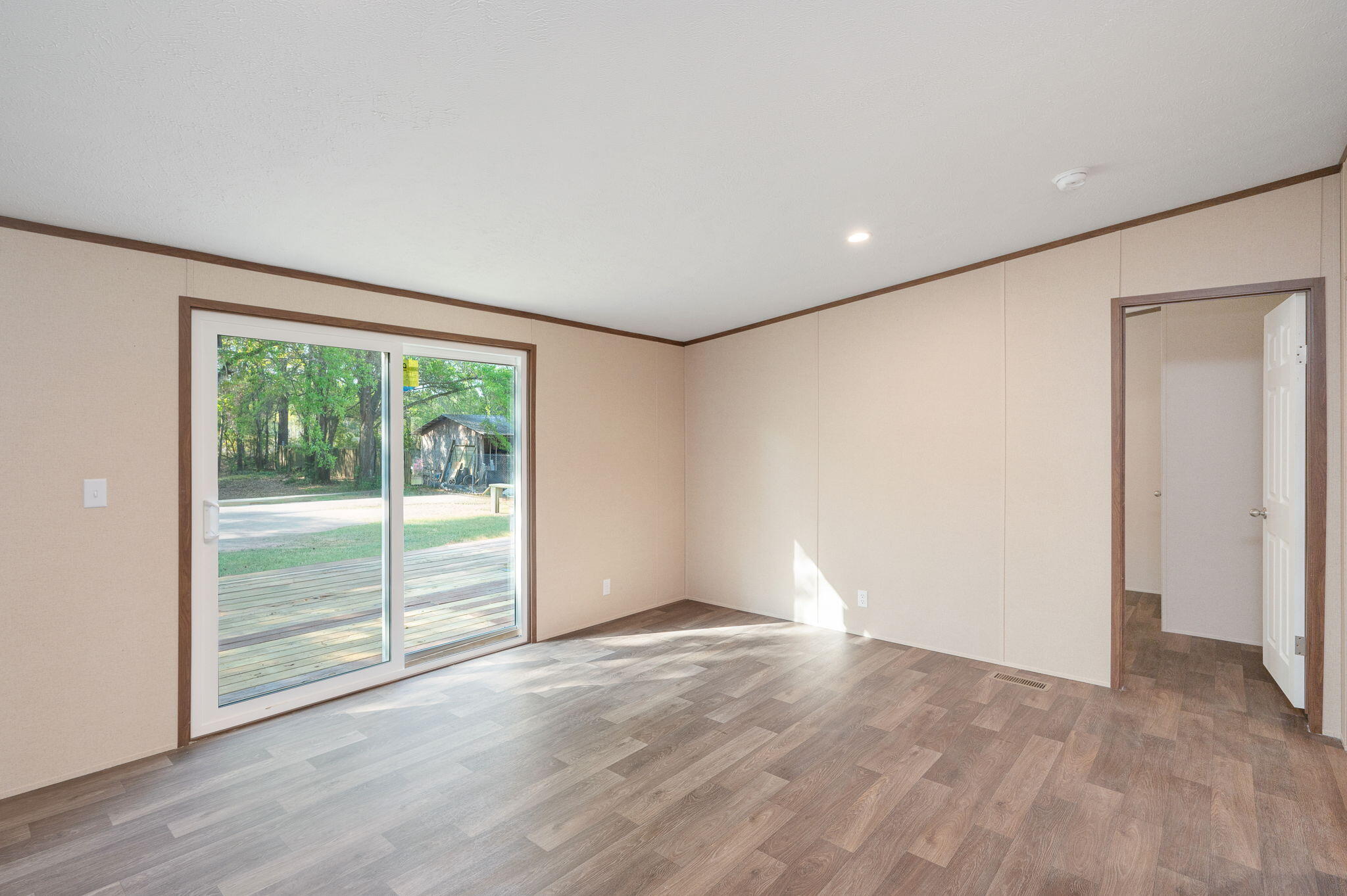 8255 Punjob Road Milton, FL 32583 - Photo 9 of 37 a view of an empty room with wooden floor and a window