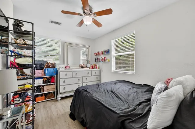 a bedroom with a bed and a book shelf