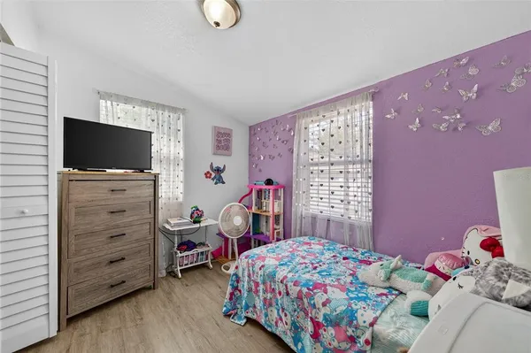 a bedroom with a bed and flat screen tv