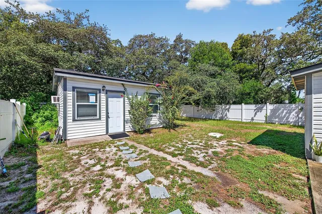 a view of a house with backyard and sitting area