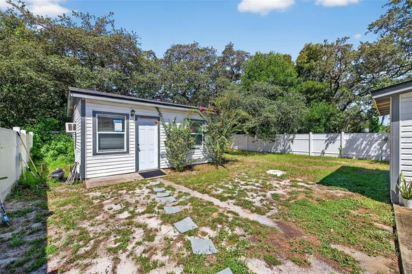 a view of a house with backyard and sitting area