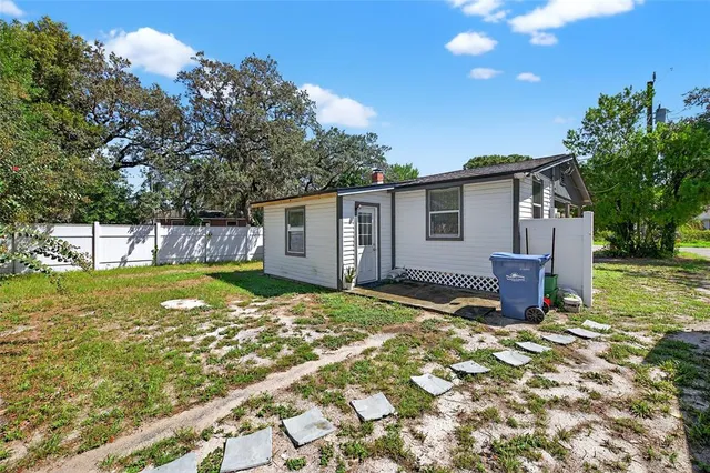a view of a house with backyard and sitting area