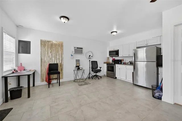a view of kitchen with refrigerator and workspace