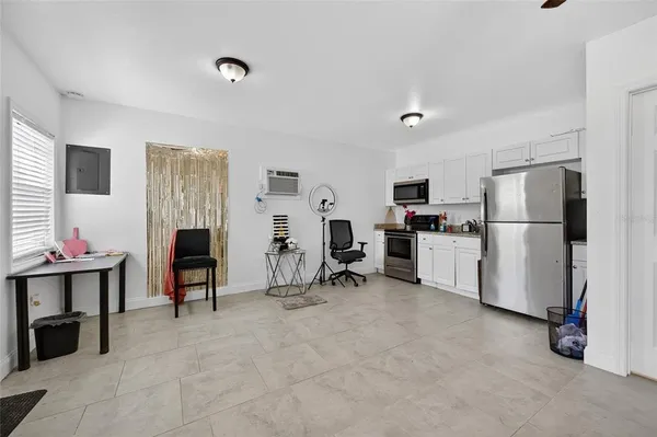 a view of kitchen with refrigerator and workspace