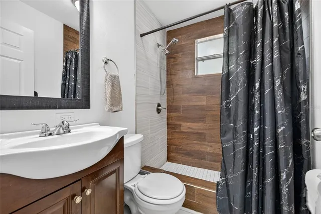 a bathroom with a sink toilet and shower