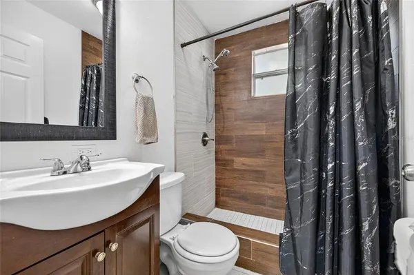 a bathroom with a sink toilet and shower