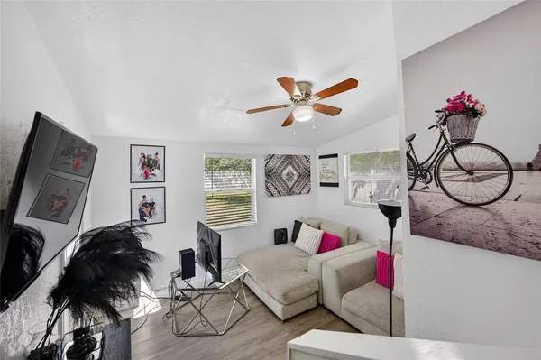a living room with furniture a rug and white walls