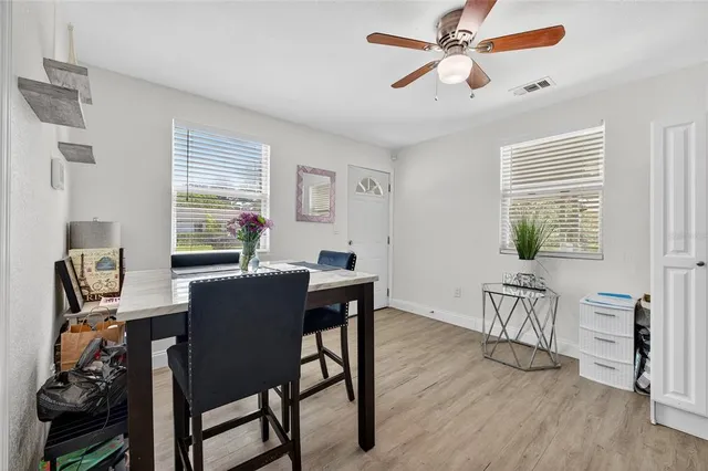 a view of a dining room with furniture and windows