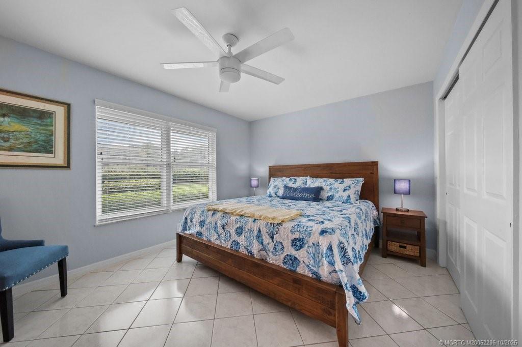 5157 Southeast Miles Grant Road Stuart, FL 34997 - Photo 13 of 32 a bedroom with a bed and a window