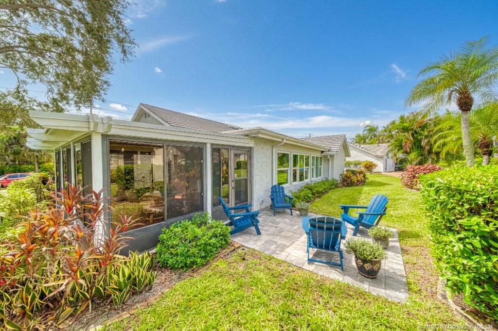 5157 Southeast Miles Grant Road Stuart, FL 34997 - Photo 18 of 32 a view of a house with backyard sitting area and garden