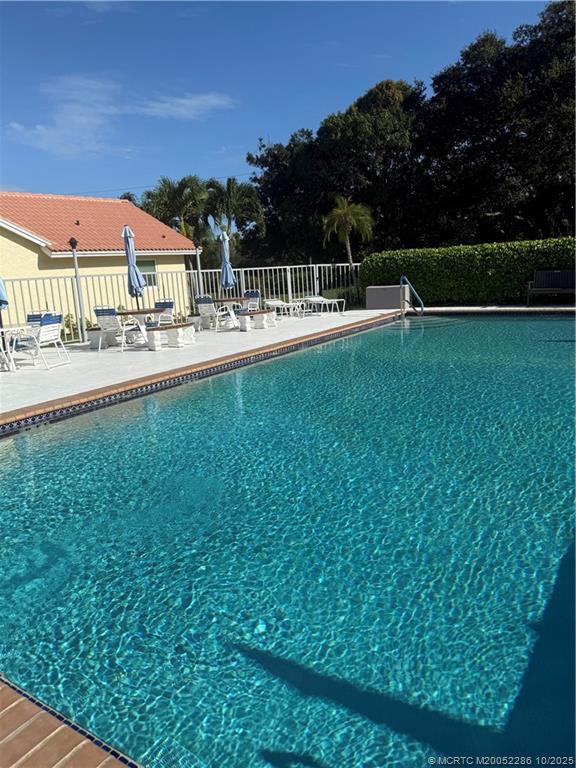 5157 Southeast Miles Grant Road Stuart, FL 34997 - Photo 21 of 32 a view of swimming pool with outdoor seating and city view