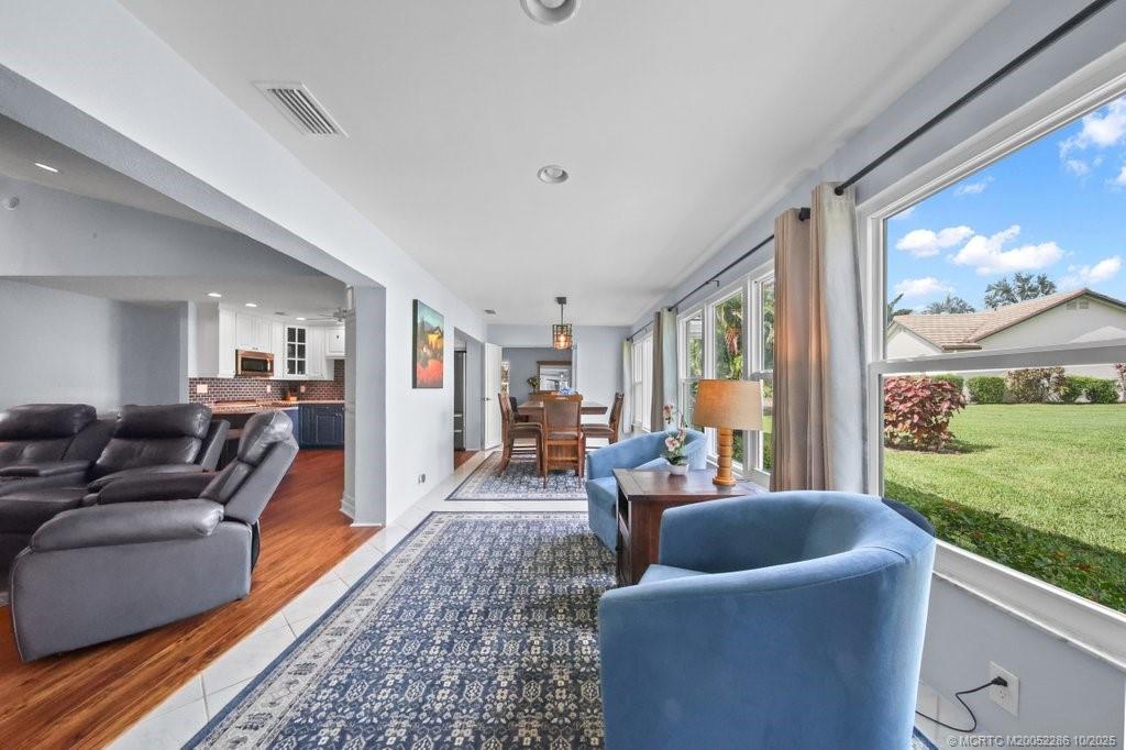 5157 Southeast Miles Grant Road Stuart, FL 34997 - Photo 9 of 32 a living room with furniture and a floor to ceiling window