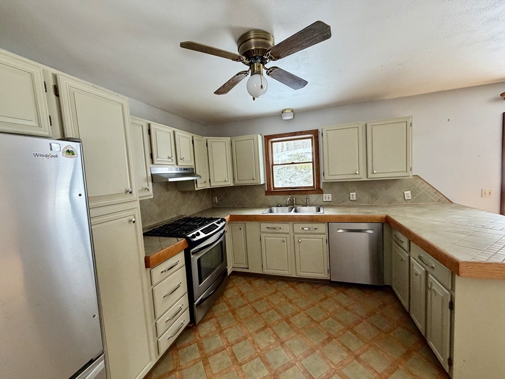 26 Falls Road Sunderland, MA 01375 - Photo 11 of 39 a kitchen with granite countertop a sink stove and refrigerator