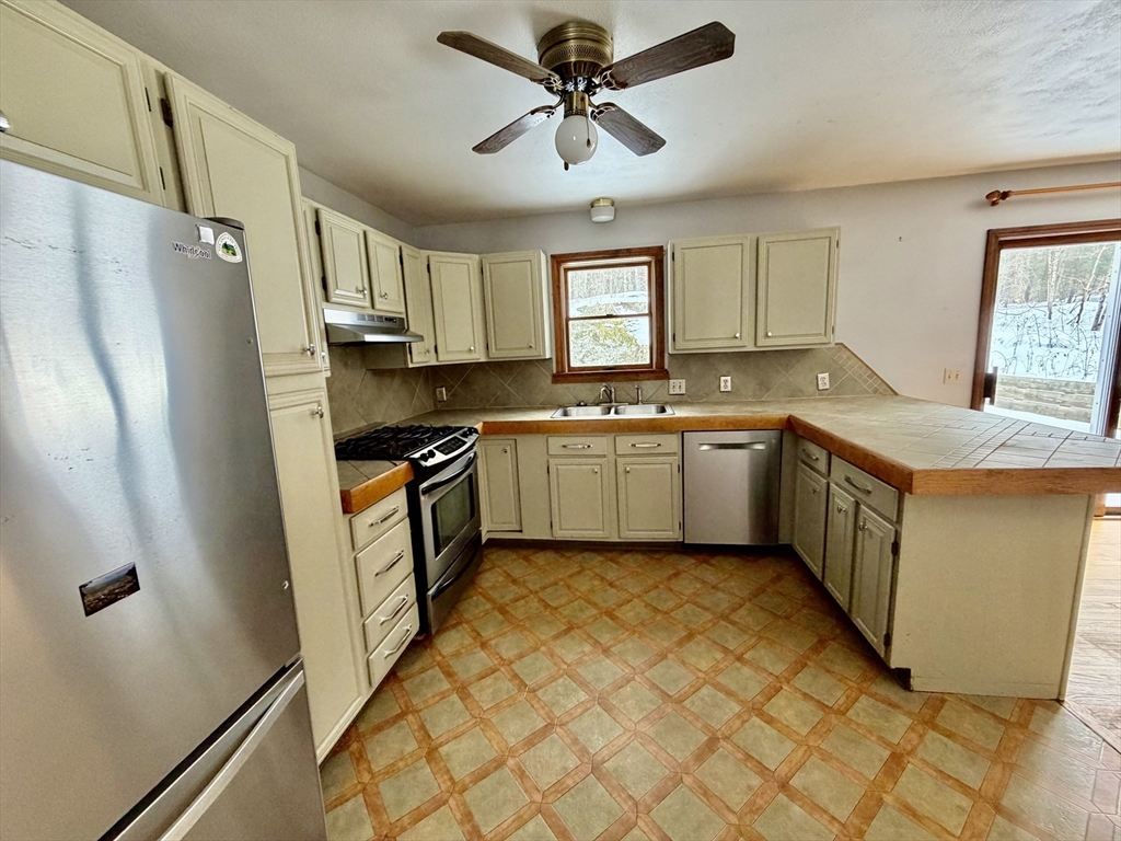 26 Falls Road Sunderland, MA 01375 - Photo 13 of 39 a kitchen with stainless steel appliances granite countertop a sink stove and refrigerator