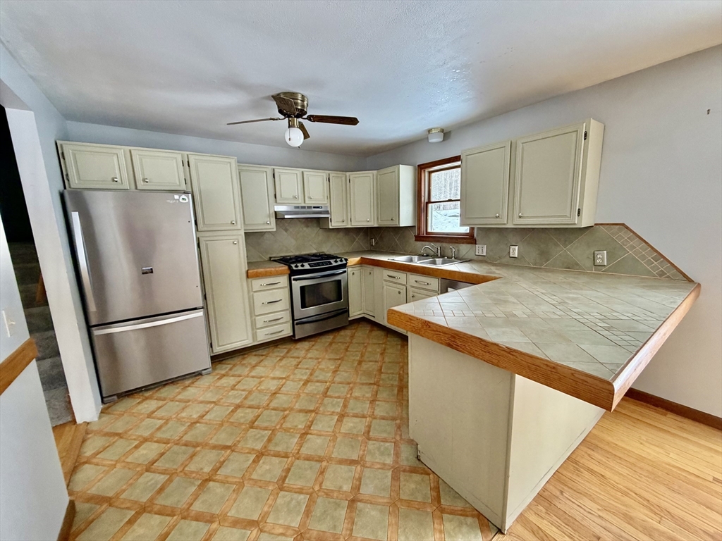 26 Falls Road Sunderland, MA 01375 - Photo 14 of 39 a kitchen with stainless steel appliances granite countertop a refrigerator a sink a stove a washer dryer and a refrigerator