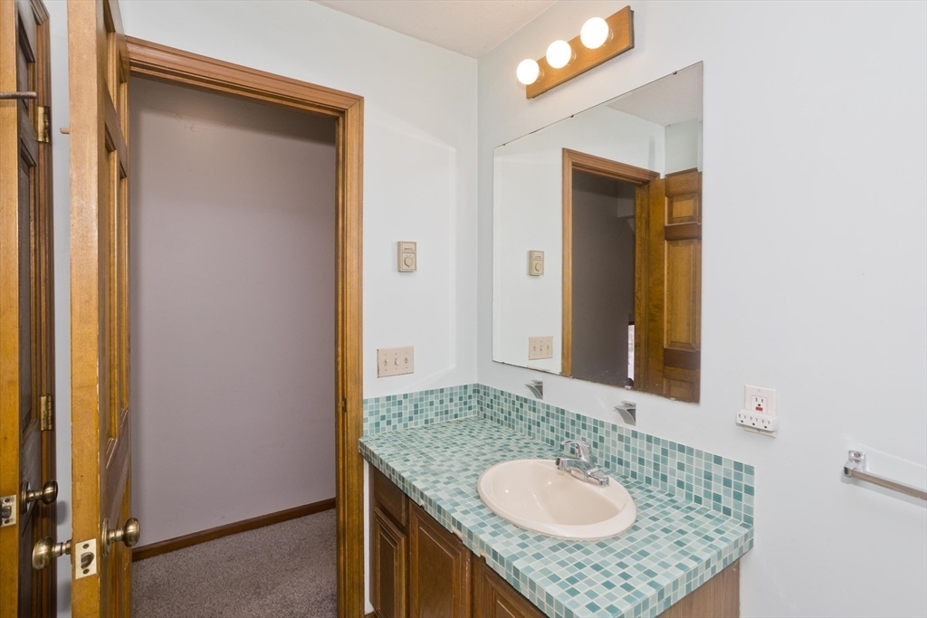26 Falls Road Sunderland, MA 01375 - Photo 30 of 39 a bathroom with a granite countertop sink and a mirror