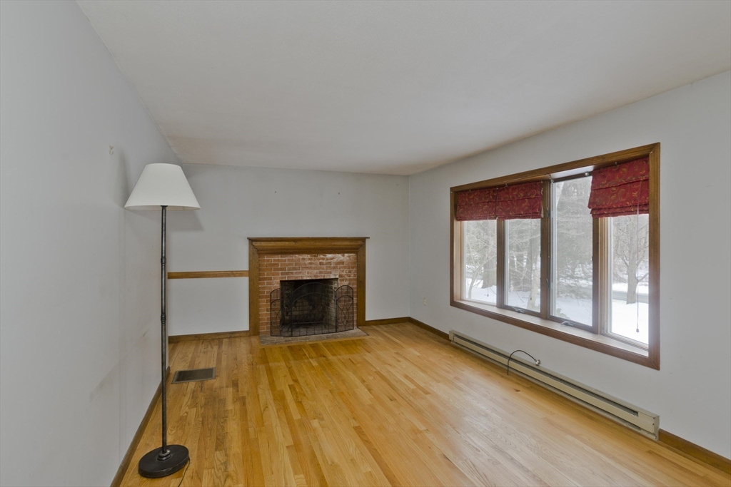 26 Falls Road Sunderland, MA 01375 - Photo 7 of 39 a view of empty room with a fireplace and wooden floor