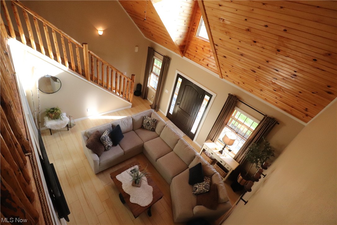 10582 Irvin Road Creston, OH 44217 - Photo 13 of 47 Living room with a wealth of natural light, light hardwood / wood-style flooring, wooden ceiling, and high vaulted ceiling
